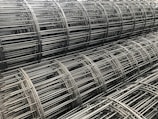 A close-up of stainless steel wire mesh rolls.