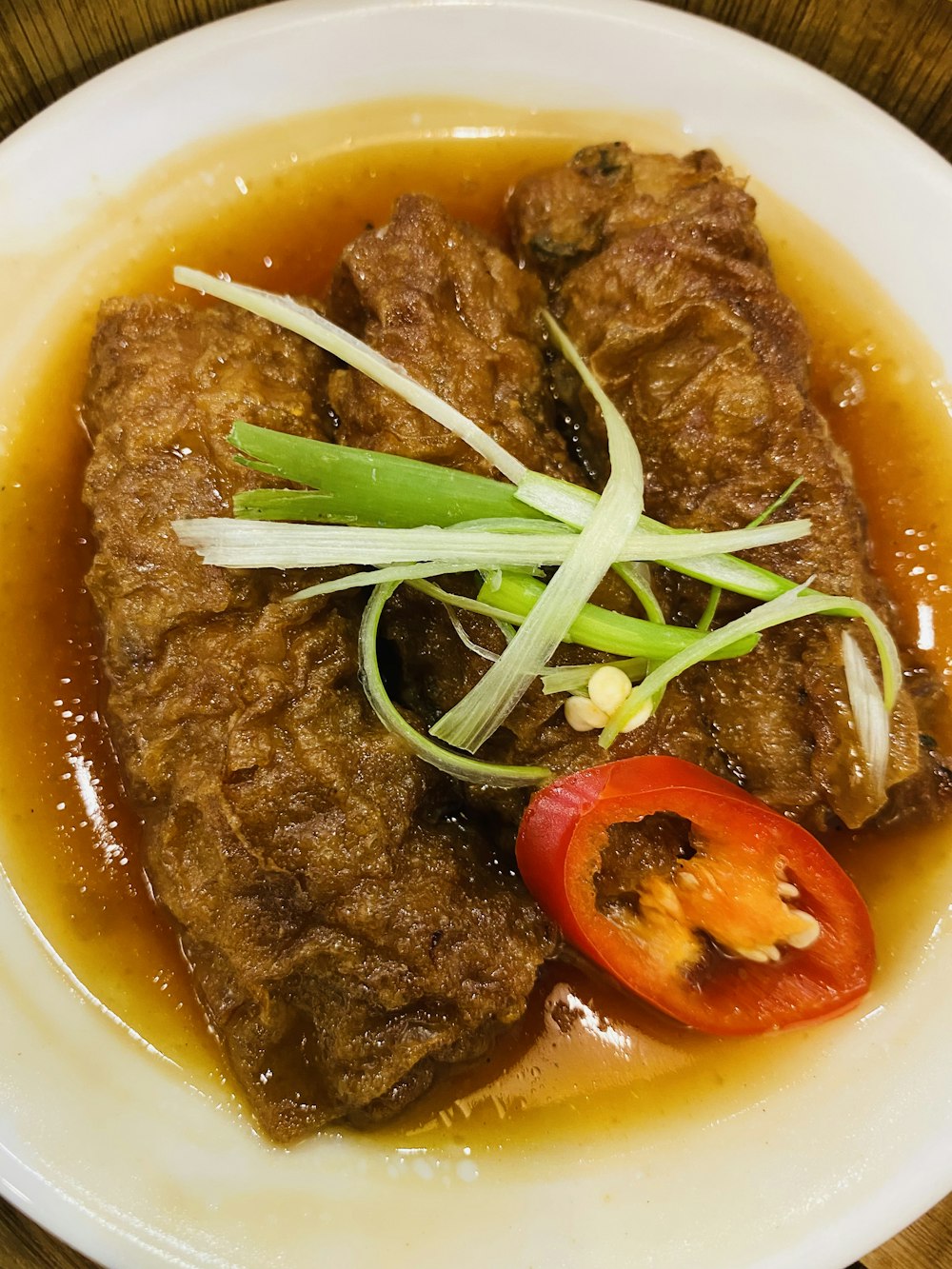 a bowl of soup with meat and vegetables