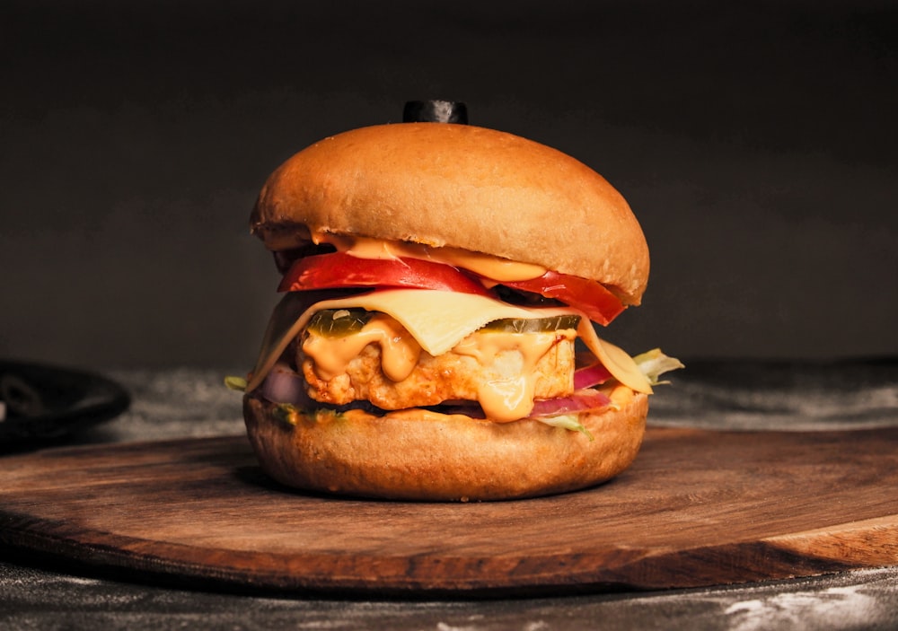 a cheeseburger on a wooden surface