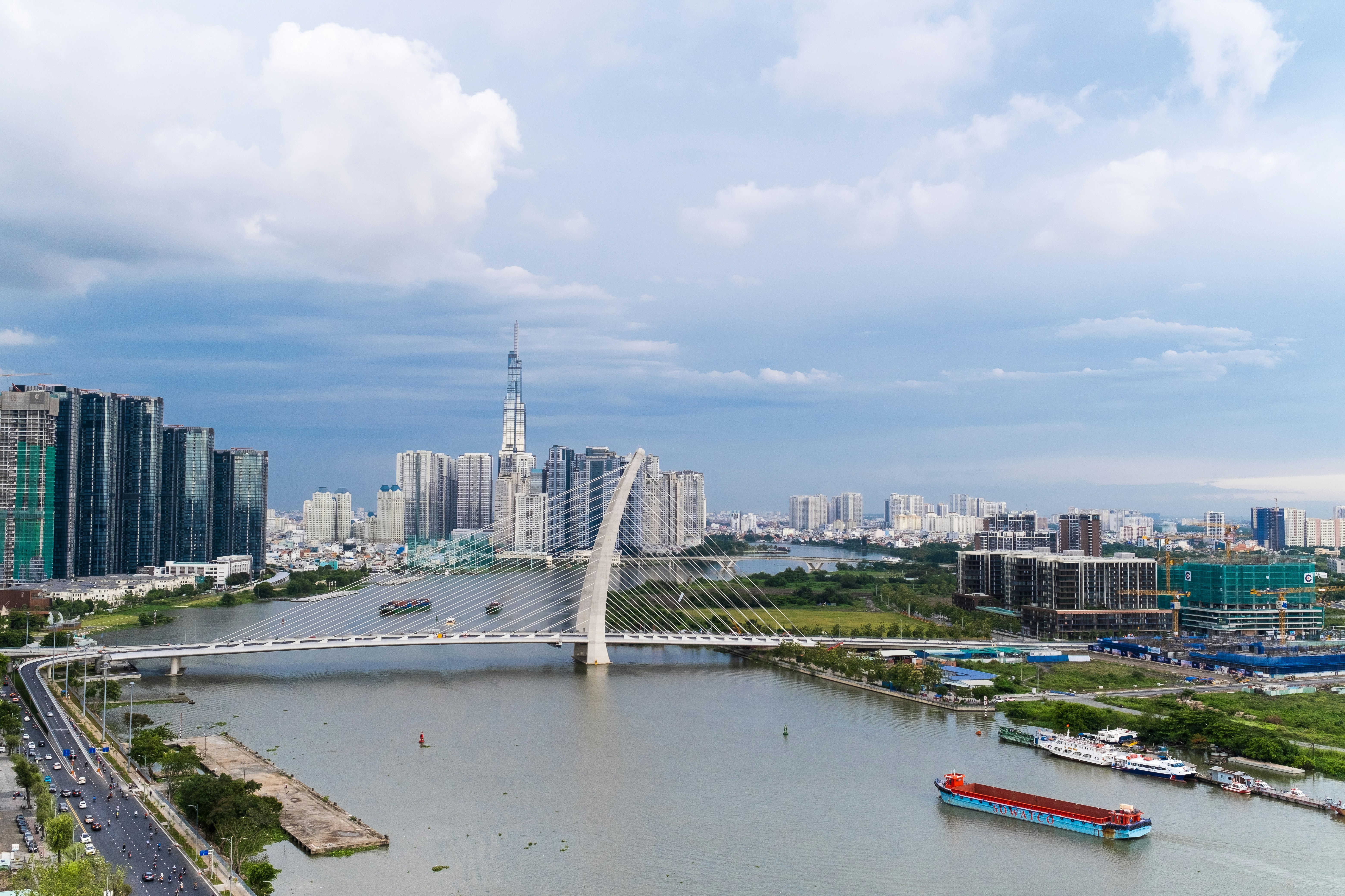a river with a bridge and a city in the background