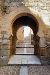 a stone walkway with a stone archway