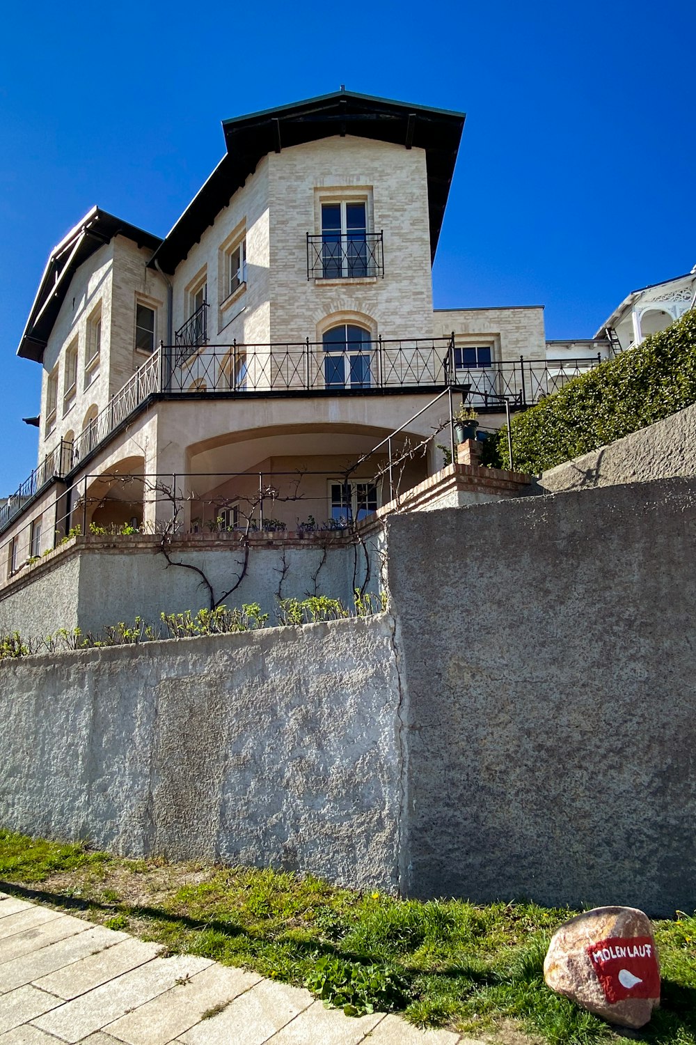 a large house with a stone wall