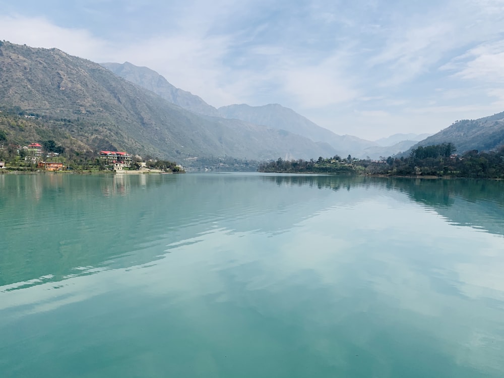 a body of water with mountains in the background