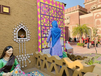 a person posing next to a statue