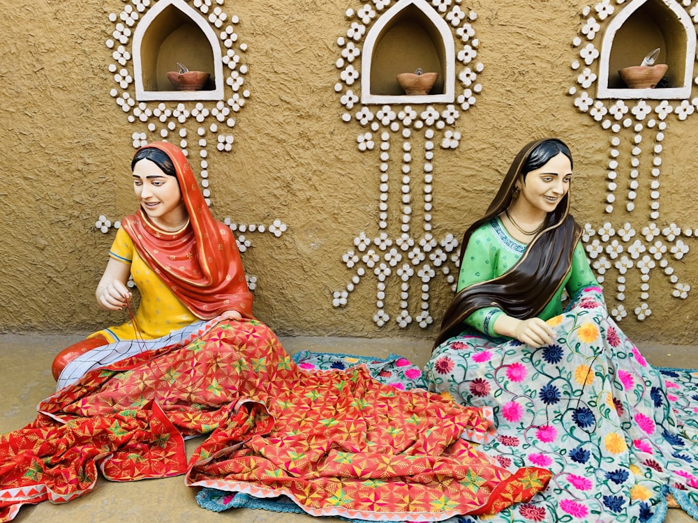 two women sitting on a bed