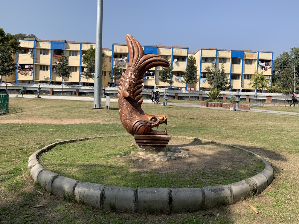 a statue of a person holding a gun in a park