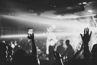 a crowd of people holding up their hands