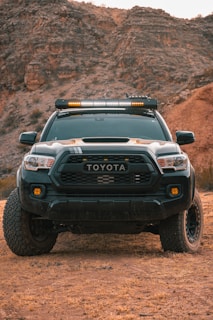 a black car on a dirt road
