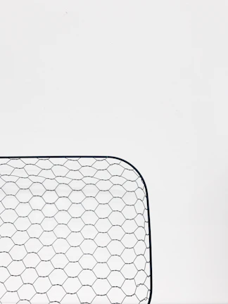 Close-up of welded wire mesh highlighting precise, uniform welds on galvanized steel.