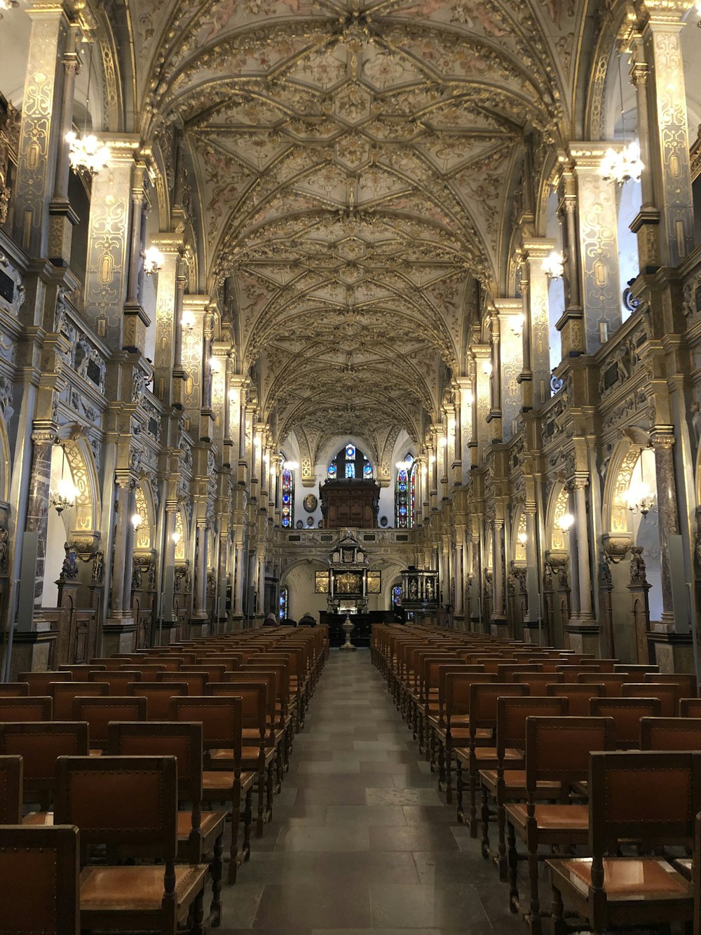 a large cathedral with rows of pews and a large chandelier