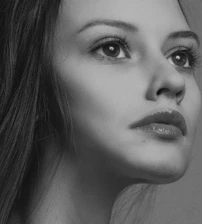 Close-up black-and-white shot of Pauline Pastel’s expressive eyes and delicate features.