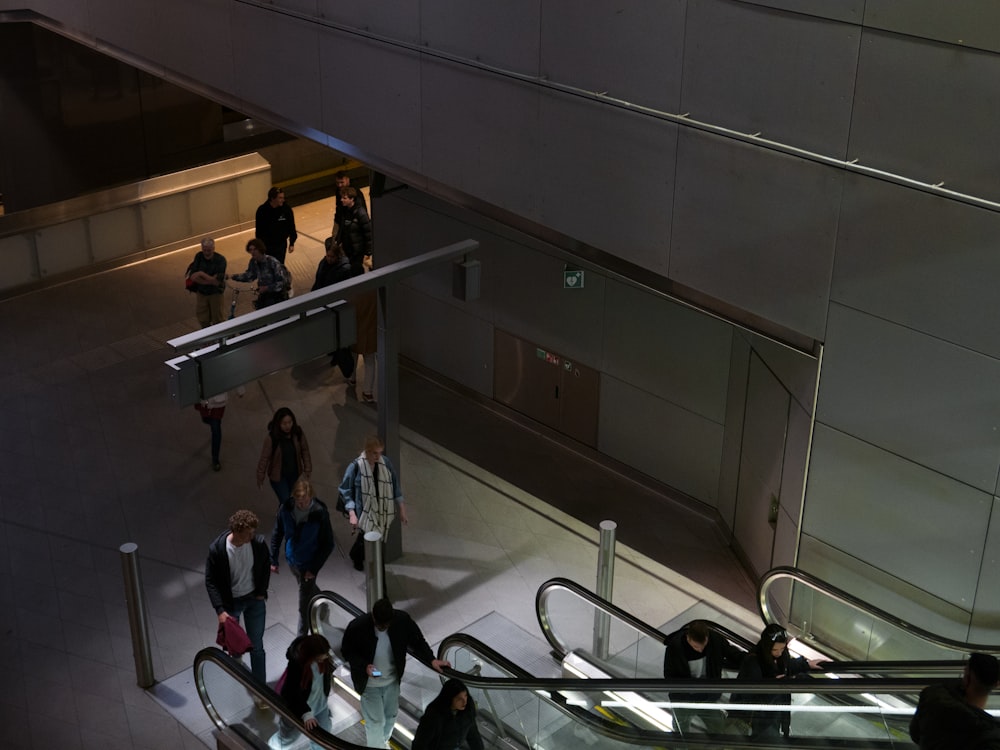 people walking down a escalator