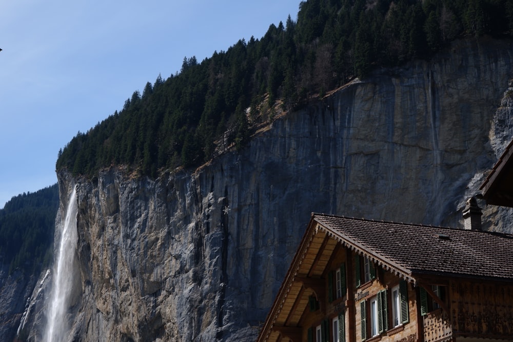 a building next to a waterfall