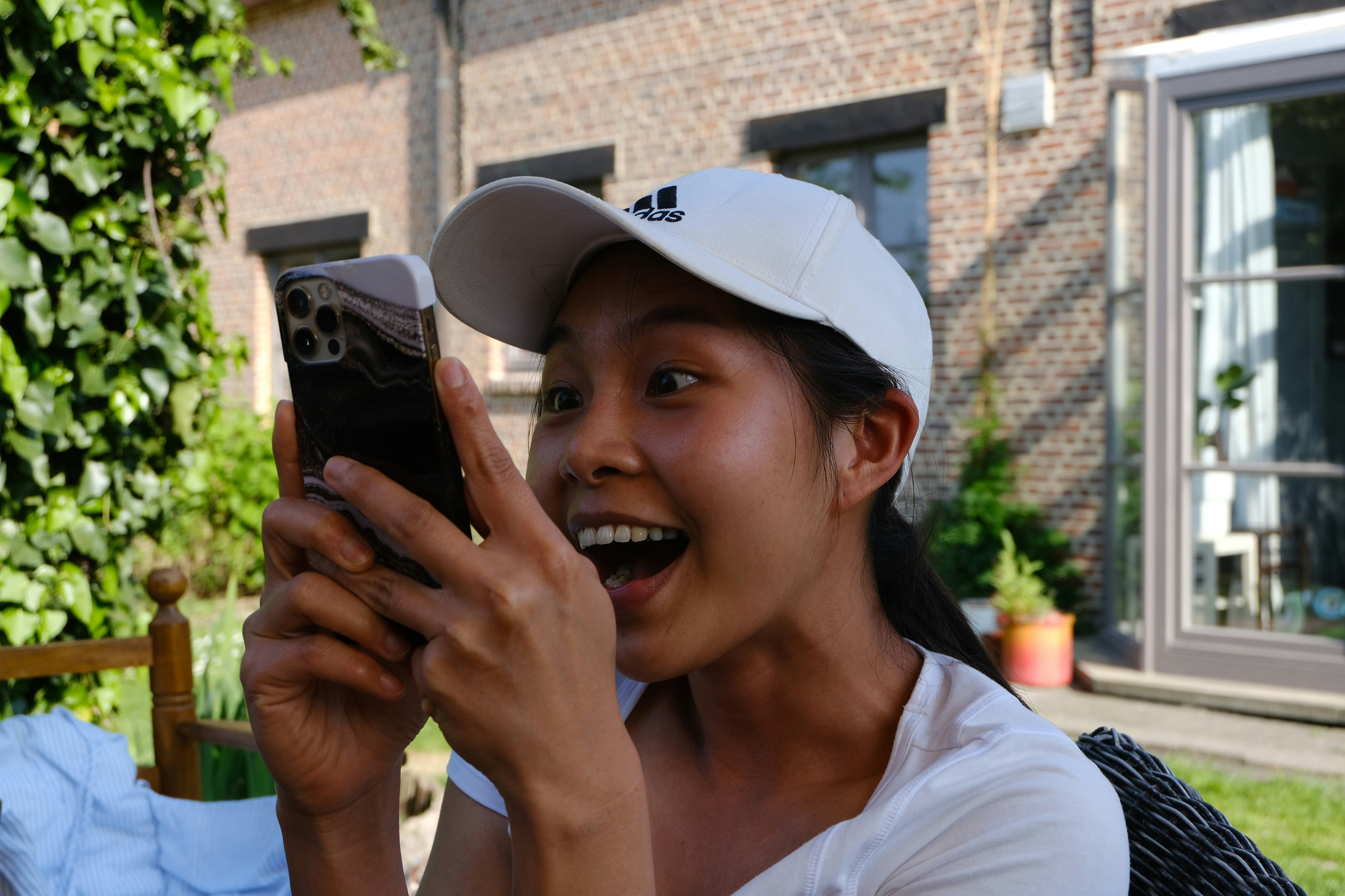 A resident smiling as they use their phone to open up a door to a fitness center - controlled access apartments