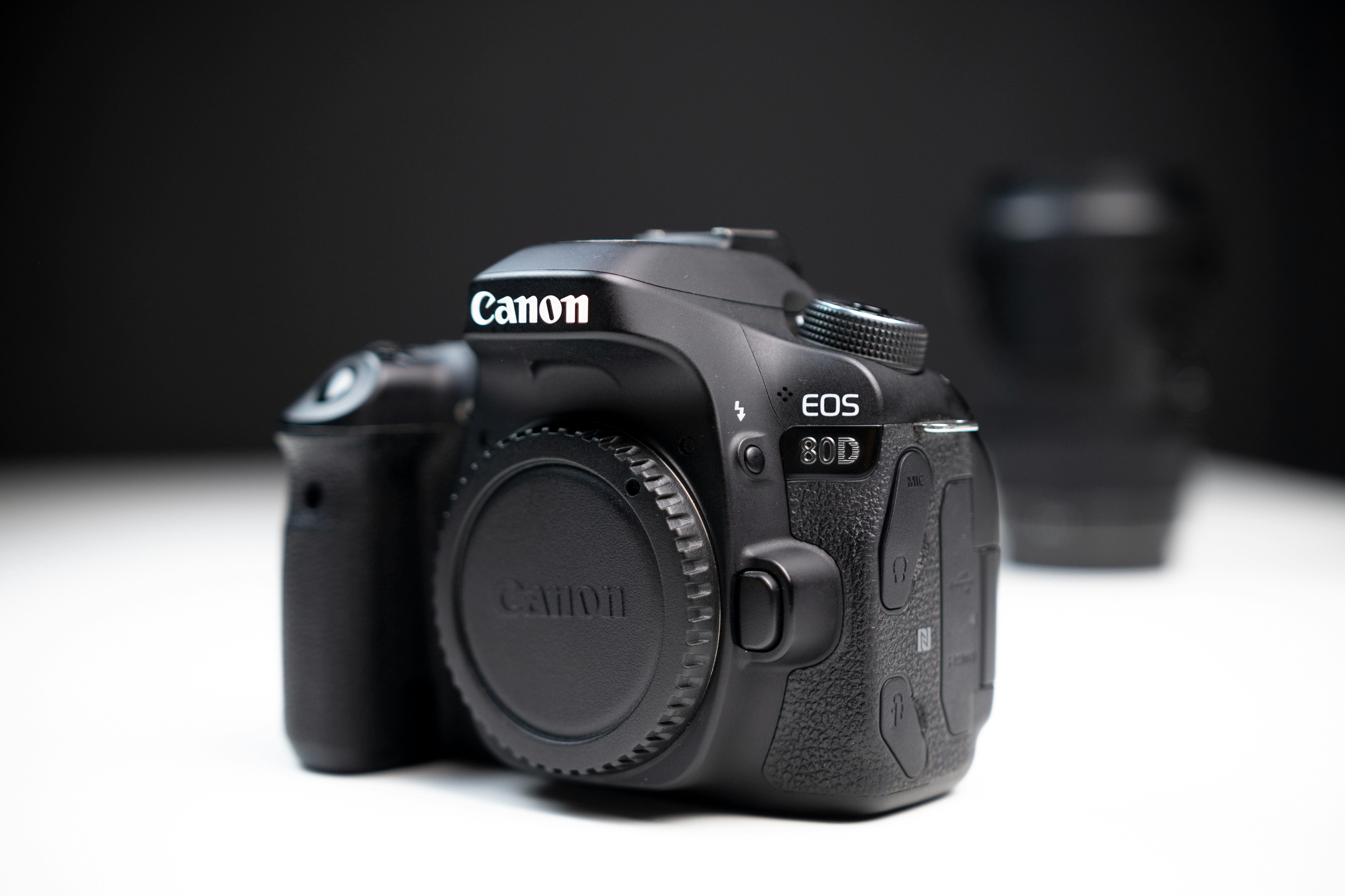 canon 80D DSLR camera body with lens in the background