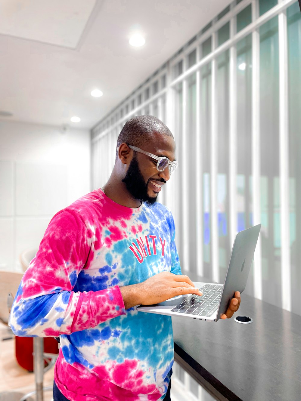 a man wearing a mask and using a laptop