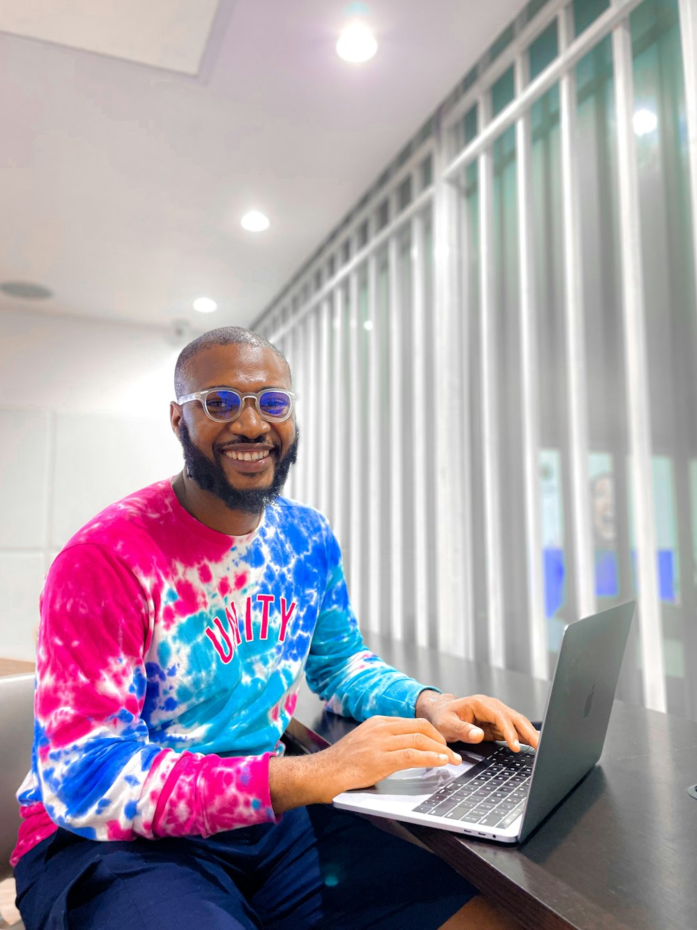 a person sitting at a desk with a laptop