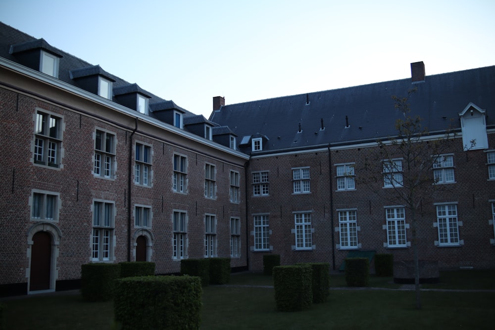 a brick building with a lawn in front of it