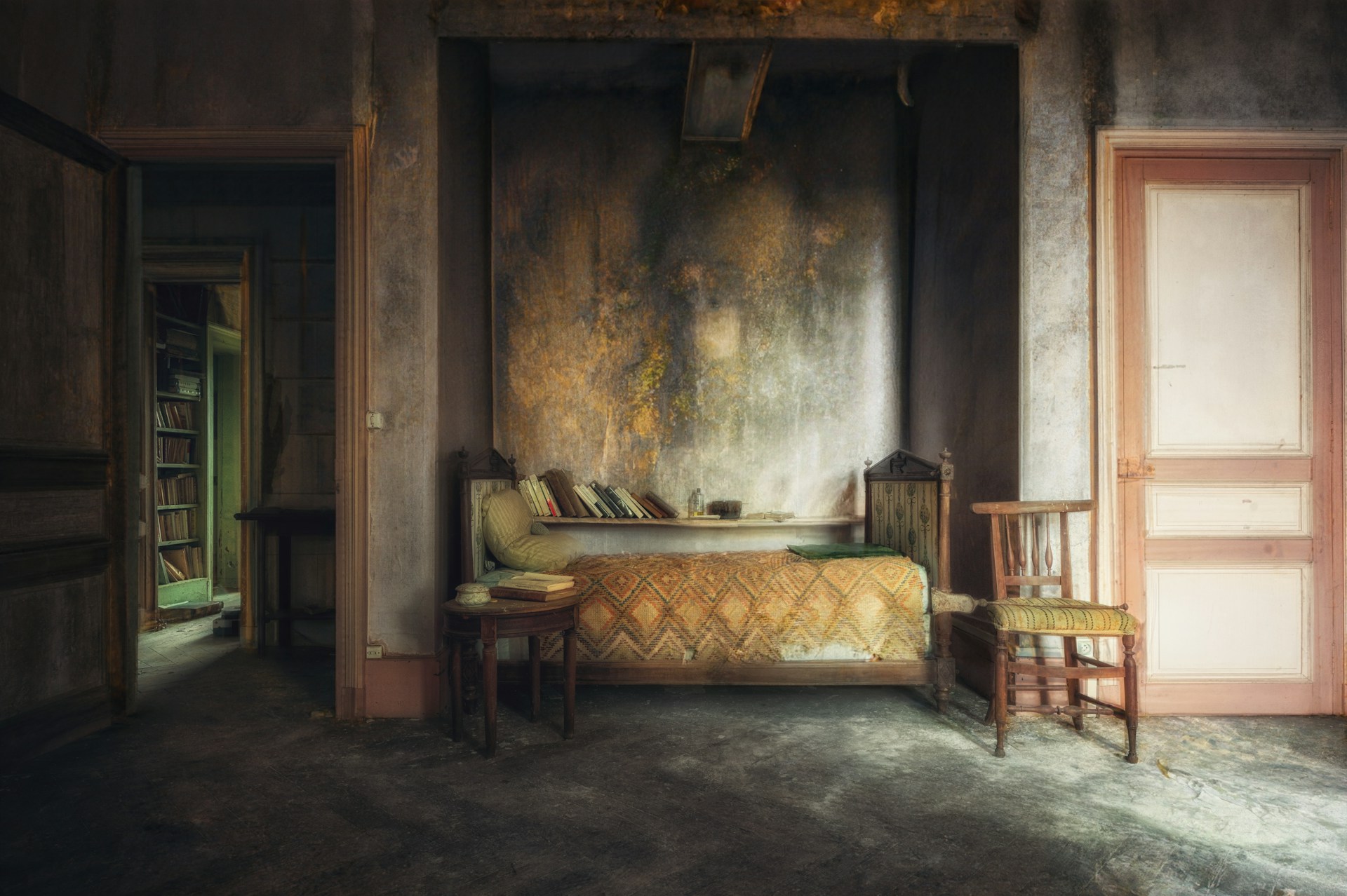A shadowy corner of a vintage bedroom with black obsidian walls, a delicate lace fabric draped across a chair bathed in muted light.