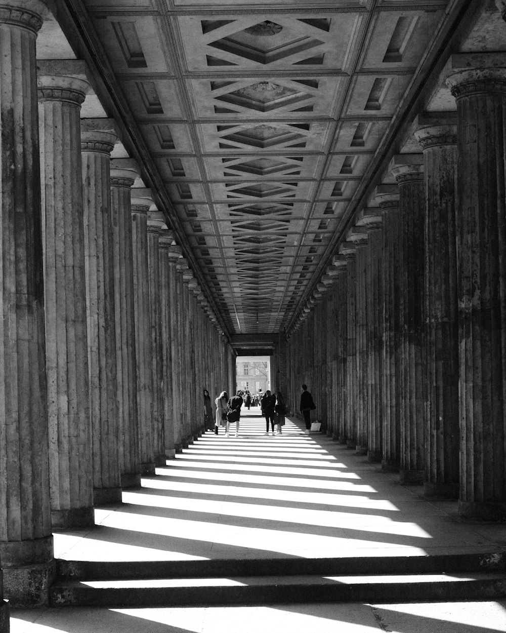 a group of people walking through a building