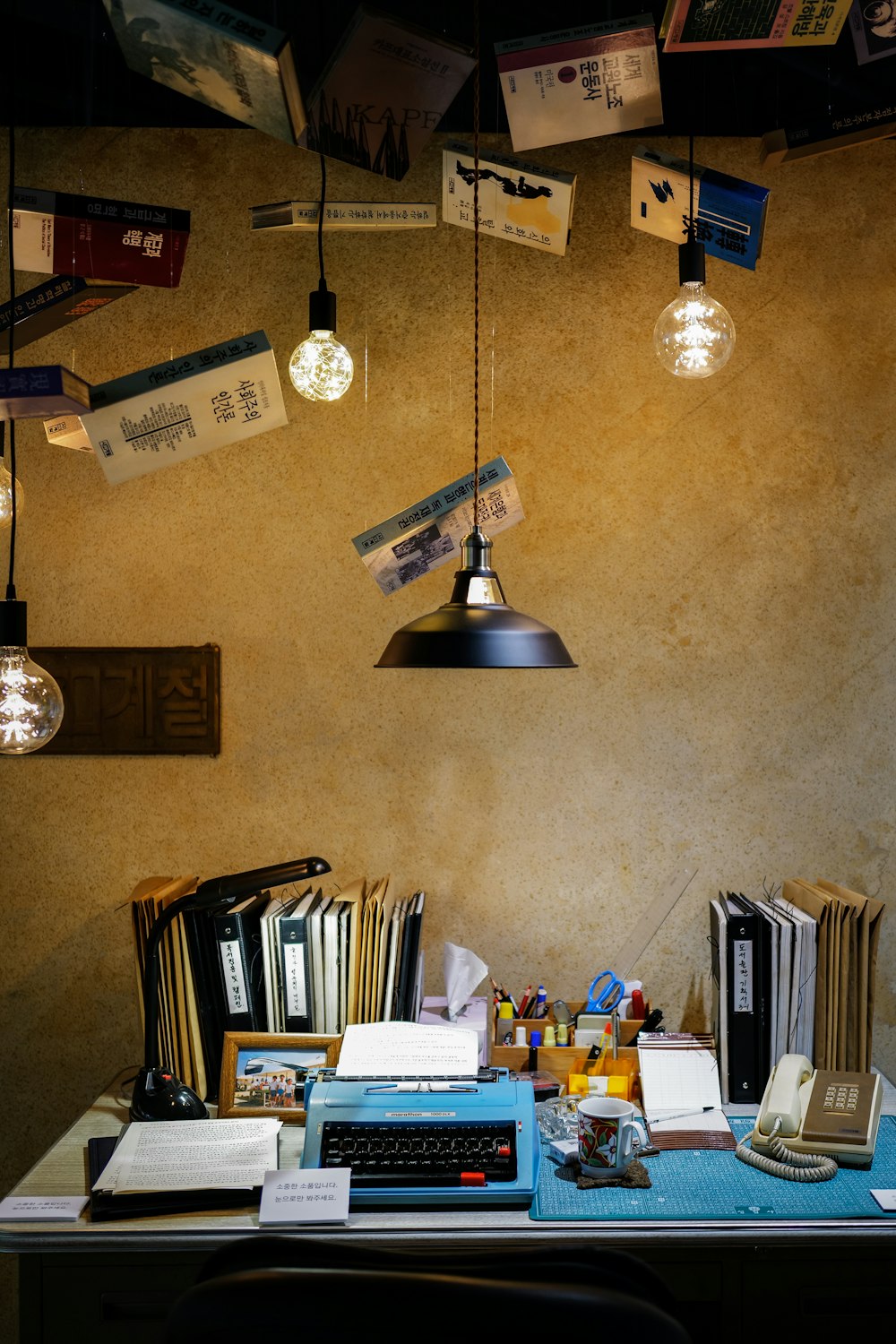 a desk with a lamp and books on it