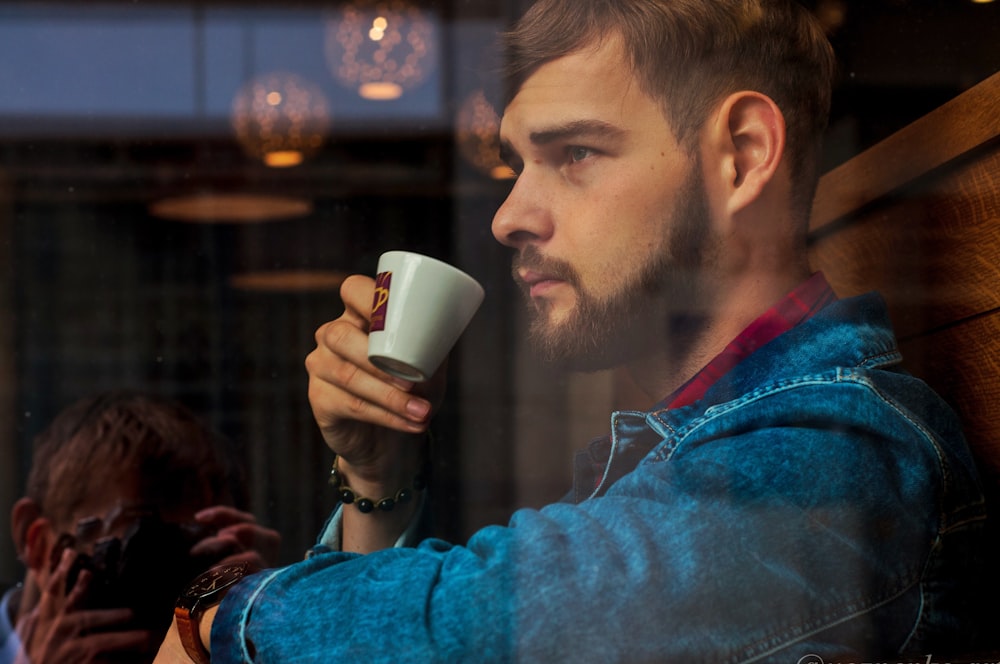 a person drinking from a cup