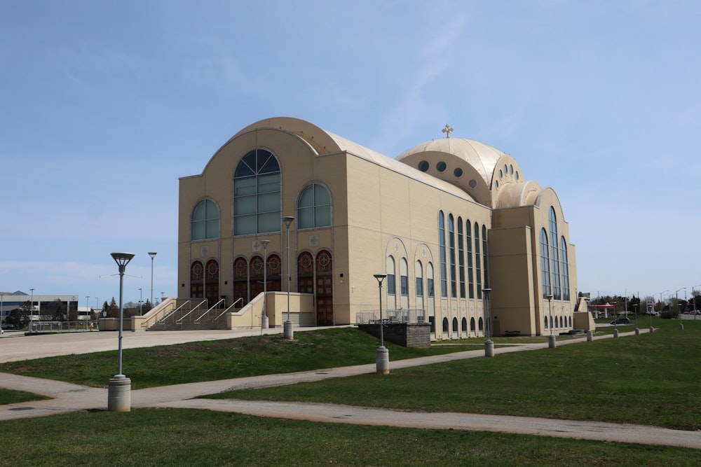 a large building with a green lawn