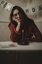 A person sitting at a table, looking sad, highlighting the effect of loneliness and social isolation