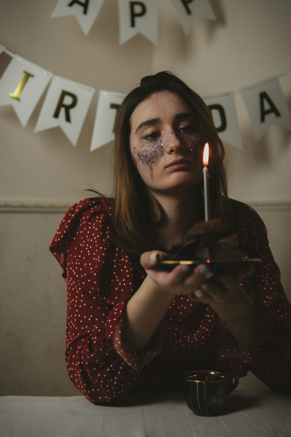 a woman holding a lit candle