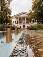 Elegant mansion featuring classic columns, a grand entrance and beautifully landscaped grounds