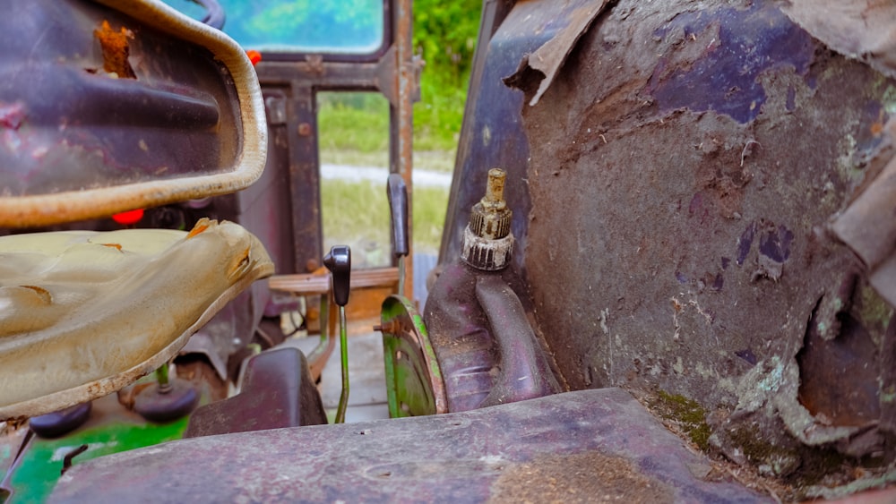 a rusted out car with a chain on the side