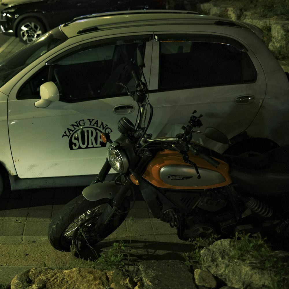 a motorcycle parked next to a car