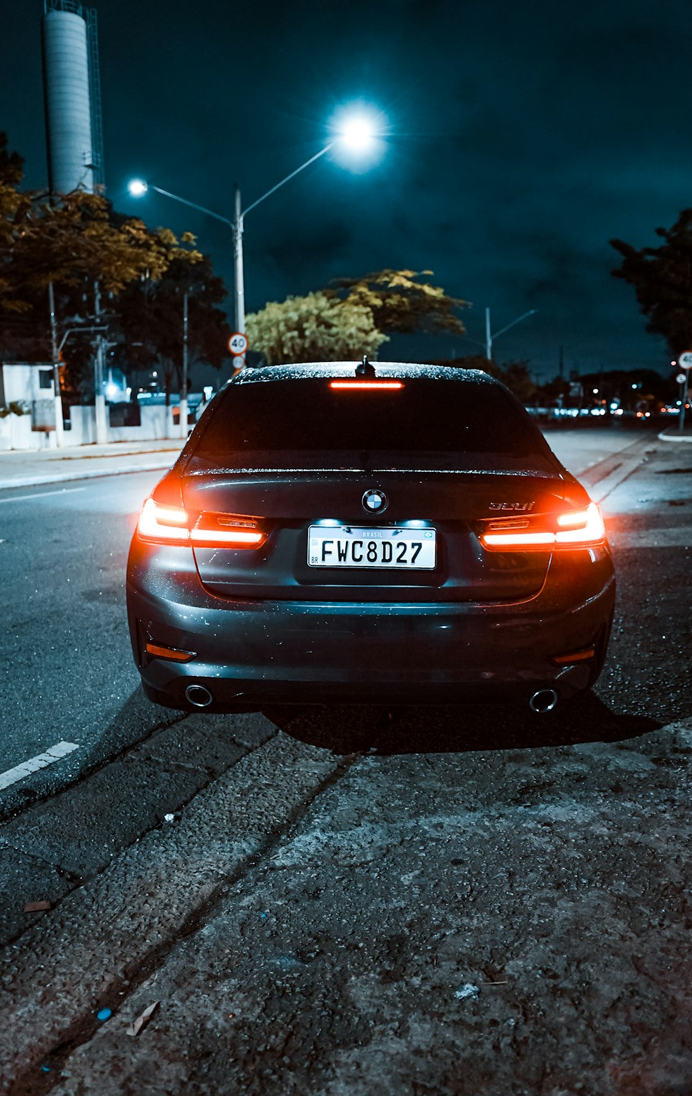 a car parked on the side of a road at night