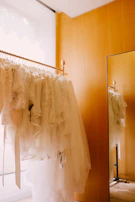 A dry cleaning rack filled with freshly pressed suits and dresses