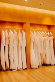 Close-up of elegant women's dresses hanging on a rack with soft lighting.