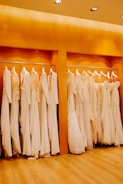 Close-up of elegant women's dresses hanging on a rack with soft lighting.