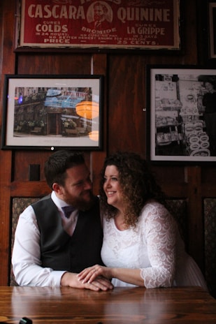 A heartfelt anniversary dinner setting, a couple holding hands as a custom song plays softly.