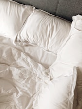 a white pillow on a bed