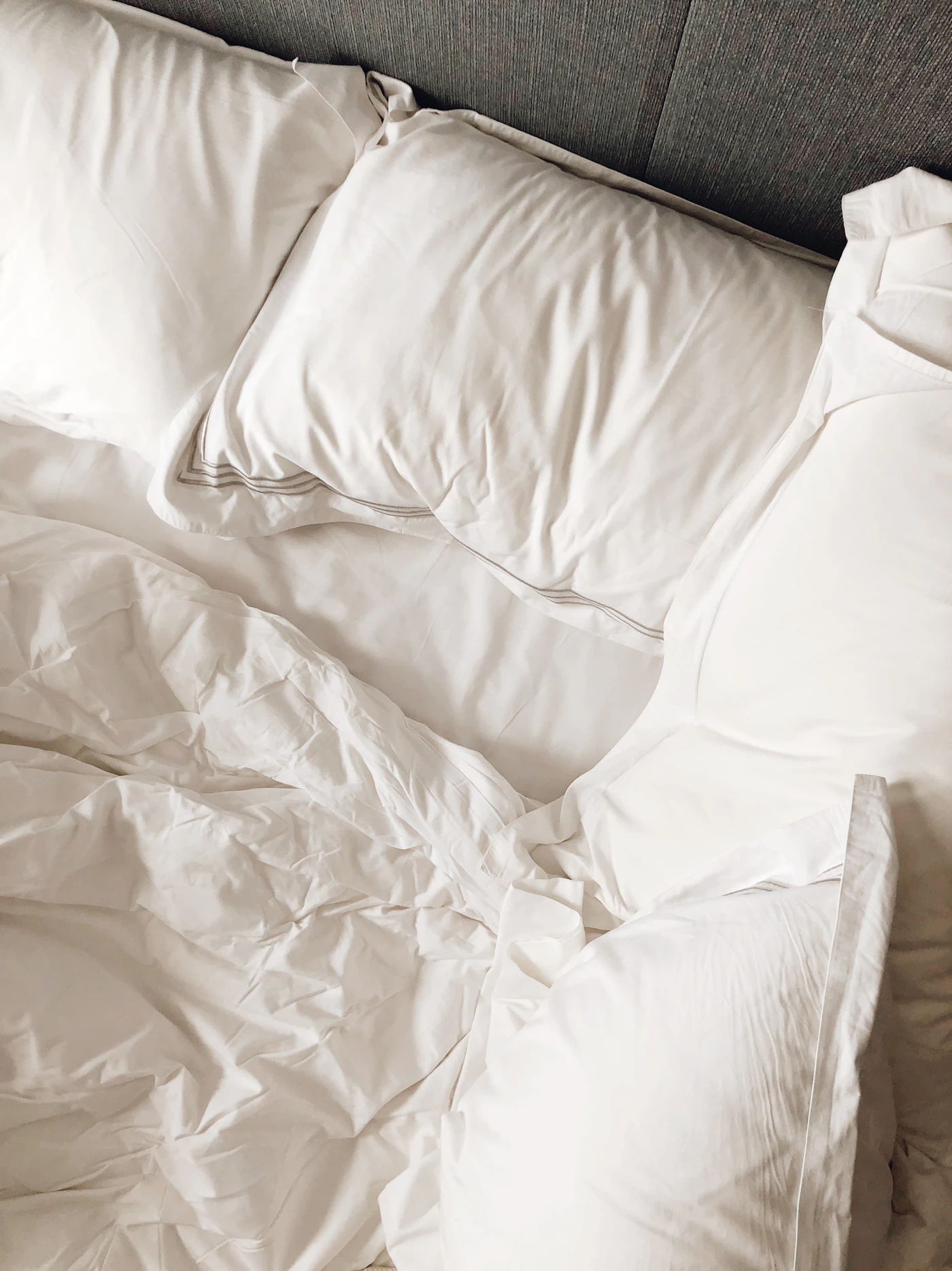 Crisp white bed sheets on a well-made bed