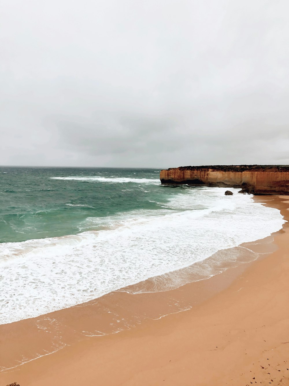 a beach with waves crashing on it