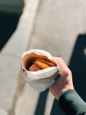 A busy Houston gas station customer enjoying a habibi deli wrap on the go.