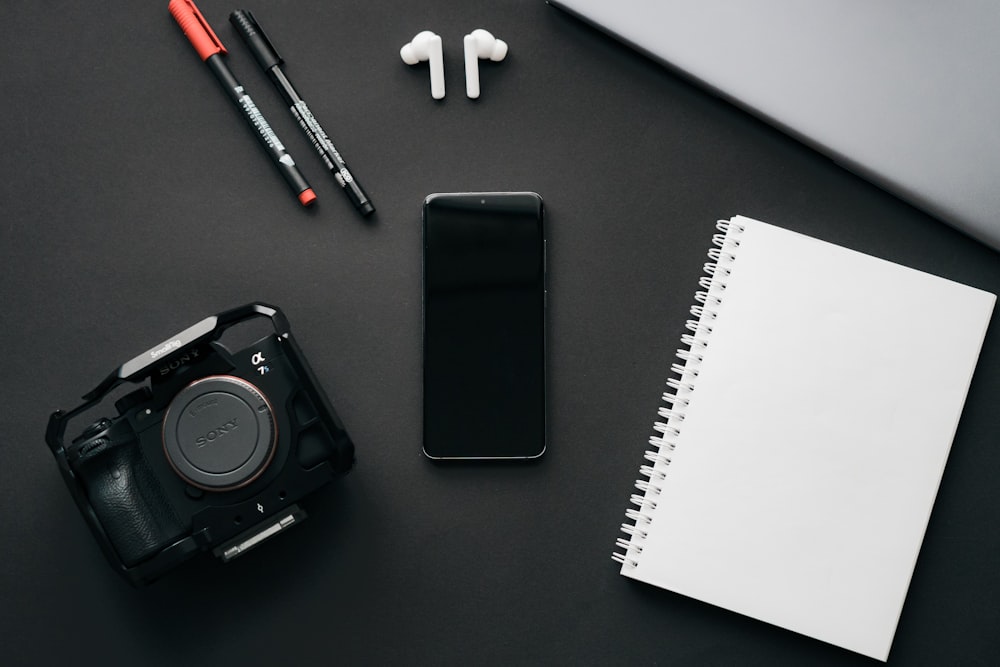 a camera and a pen on a table