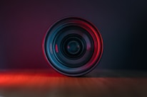 A close-up of a camera lens with artistic lighting.