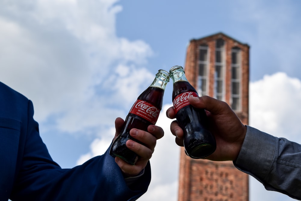 a couple of people holding bottles