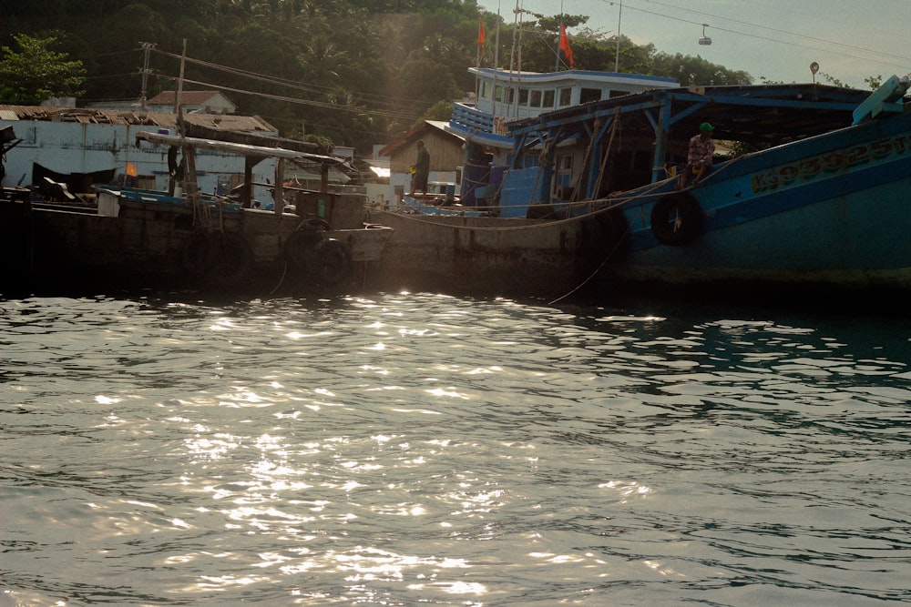 a boat is docked next to a body of water