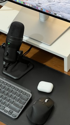 A sleek workspace showing duetech's fast chargers, durable cables, and phone cases arranged neatly with a backdrop of German engineering blueprints.