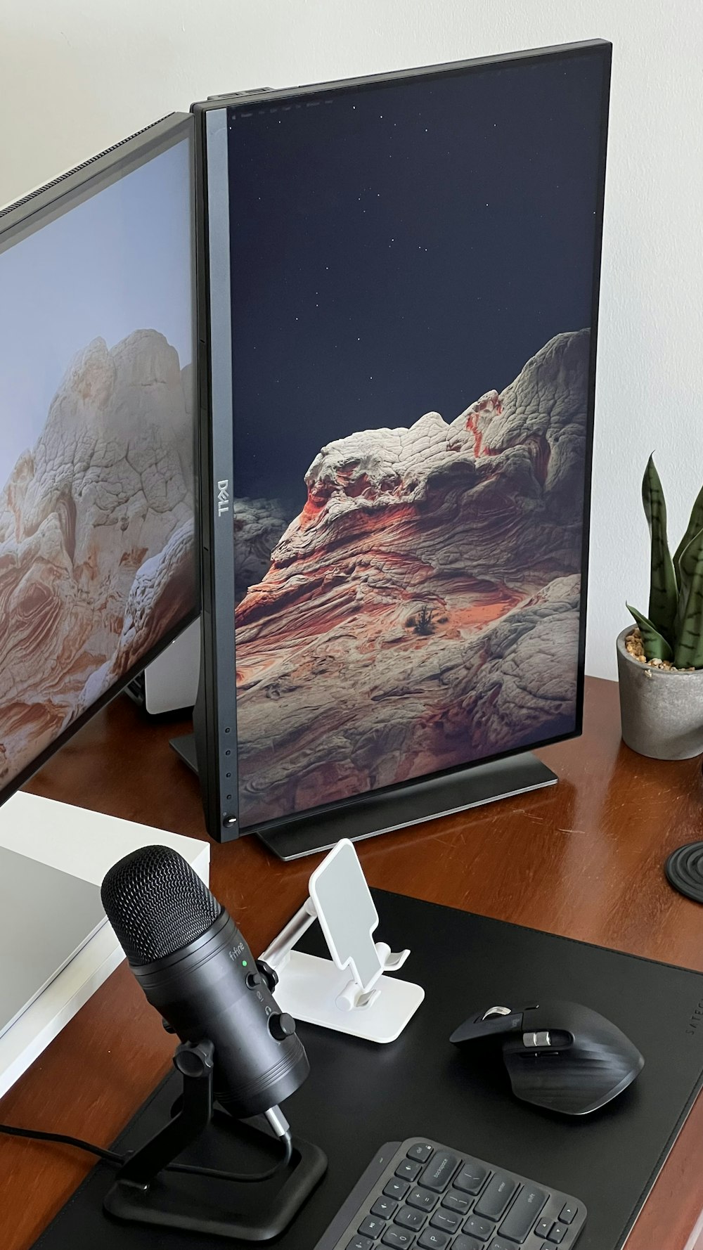 a desk with a computer and a camera on it