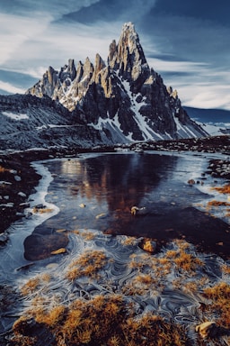 landscape photography,how to photograph peak paternkofel.; a large waterfall over a body of water