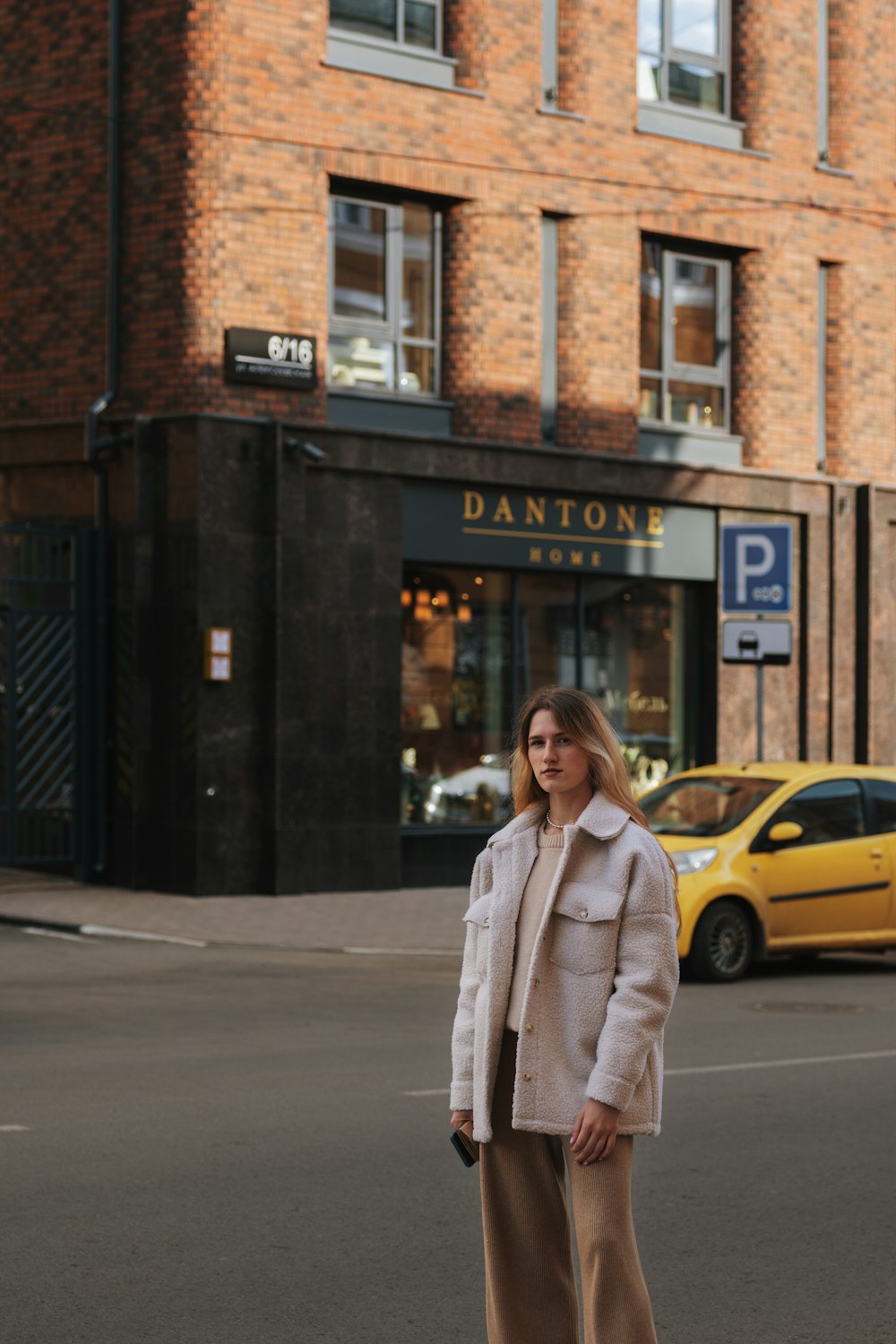 a person standing in front of a brick building