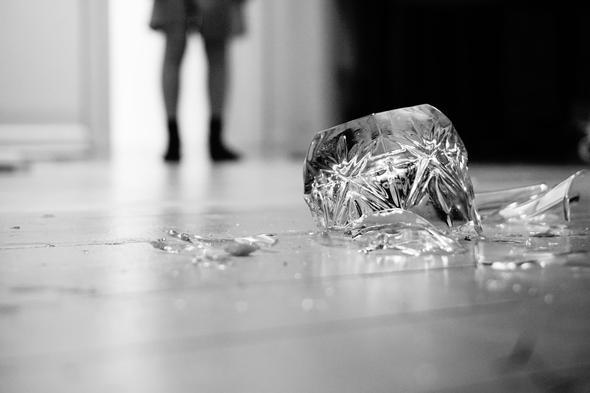 Broken drinking glass representing accidental property damage covered by personal liability insurance